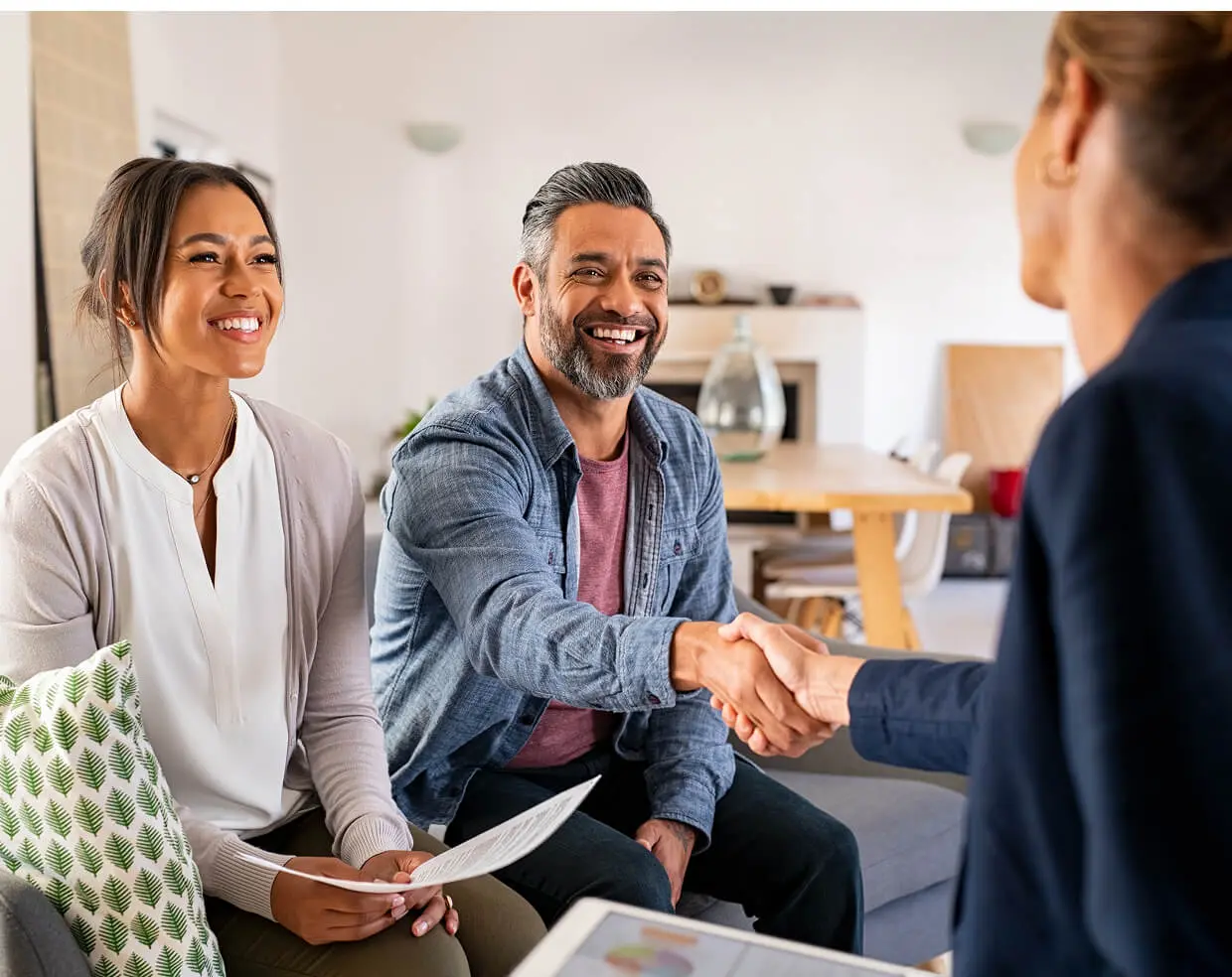 Couple meeting with a professional, shaking hands.